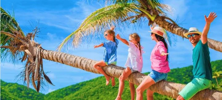 A family with children on a beach in Bali looking at the ocean